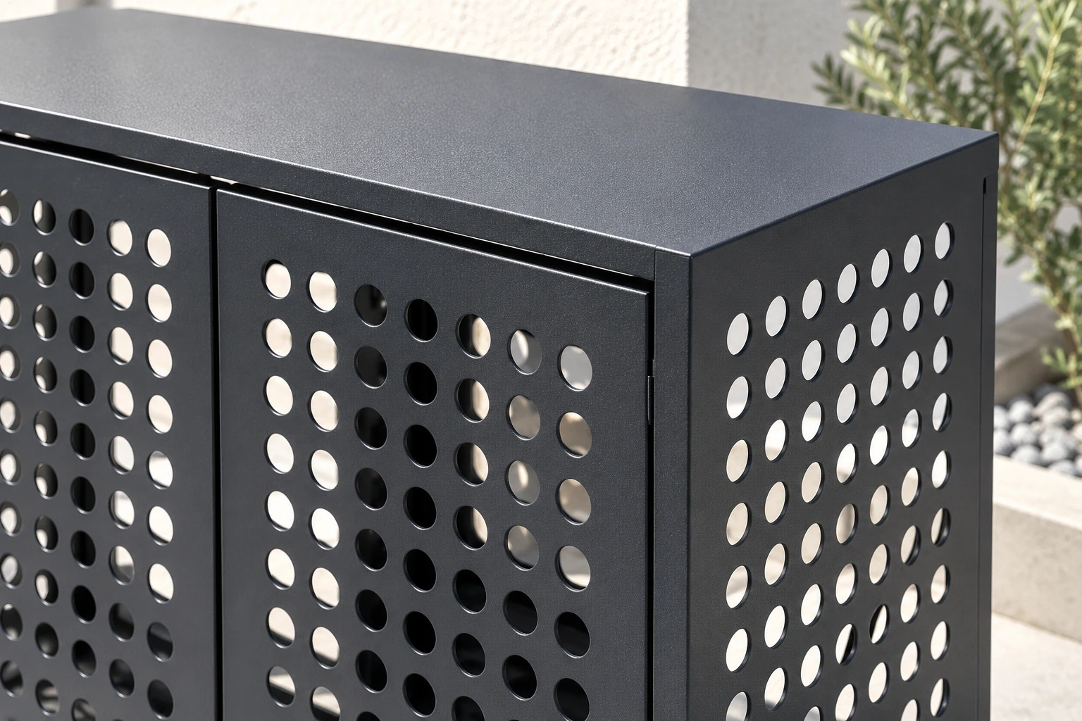 Close view of circular ventilation openings across the front and side of a charcoal cover