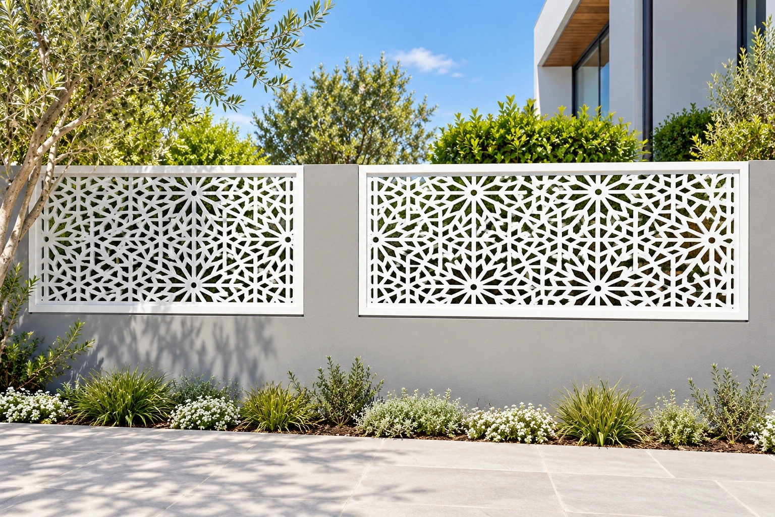White geometric composite screen panels above a low courtyard wall